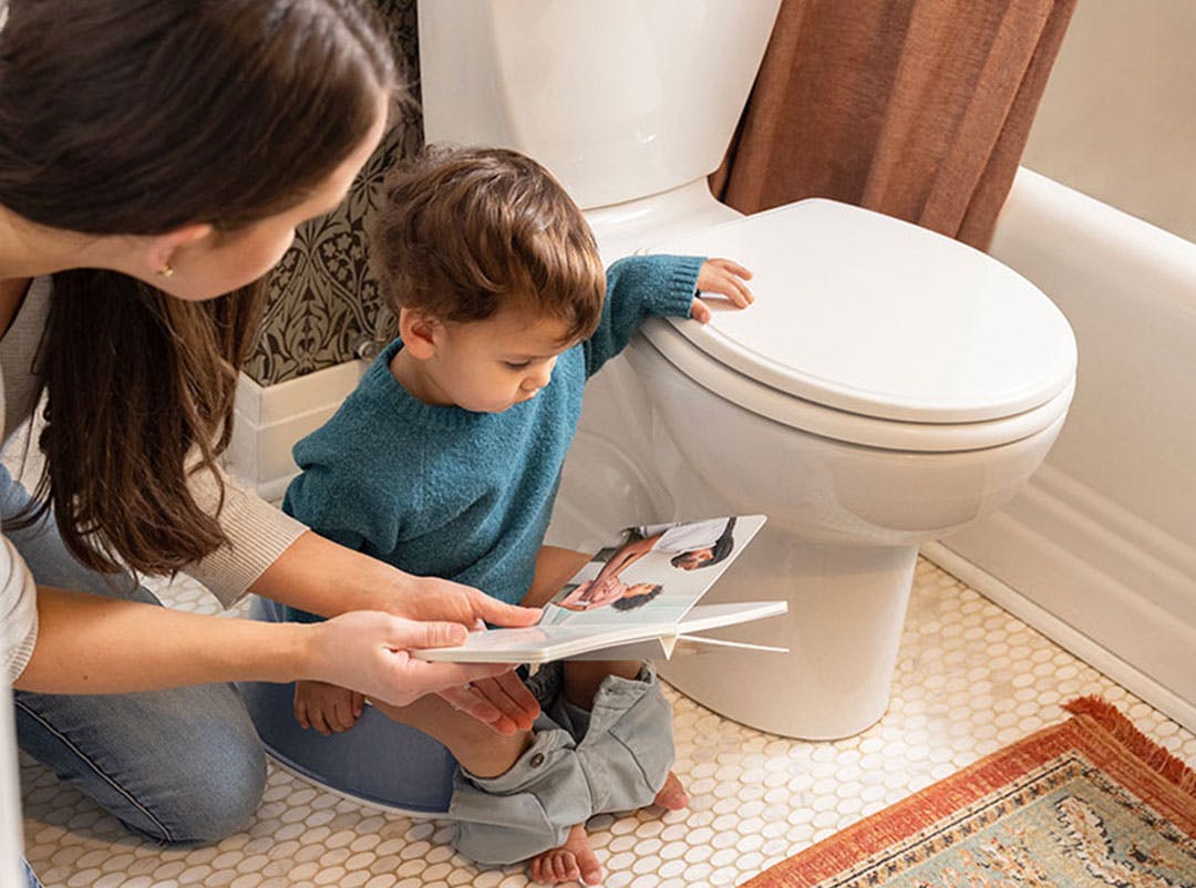 Little boy on potty reading book