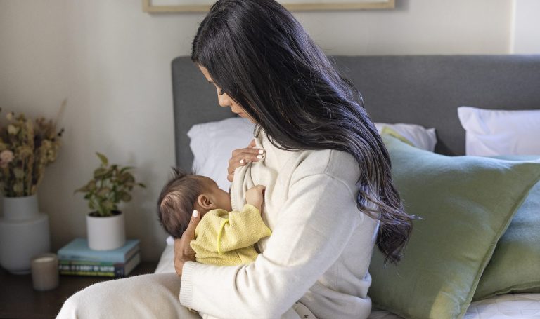 Mother breastfeeding their baby