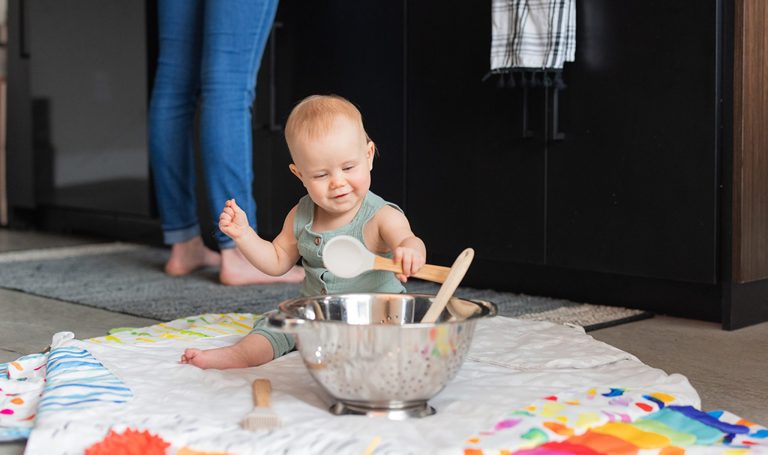 Baby playing with kitchen utensils