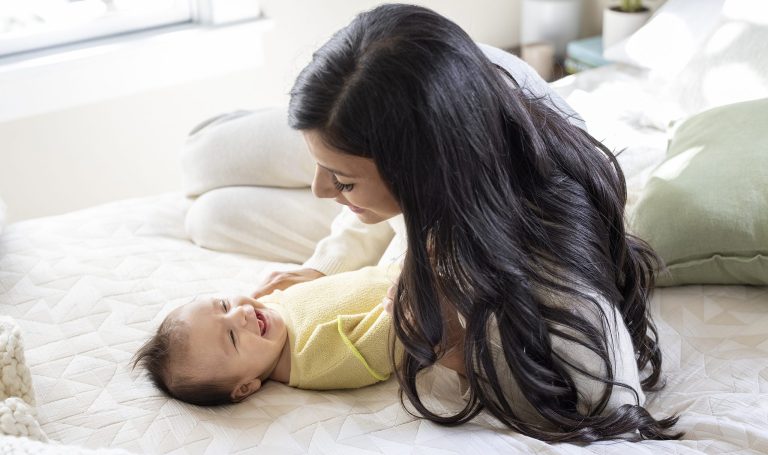 Baby smiling at their mother