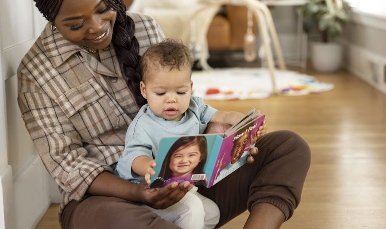 Baby and mother looking at a Lovevery book