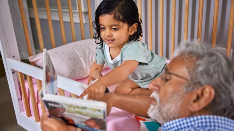 Caregiving reading to a toddler