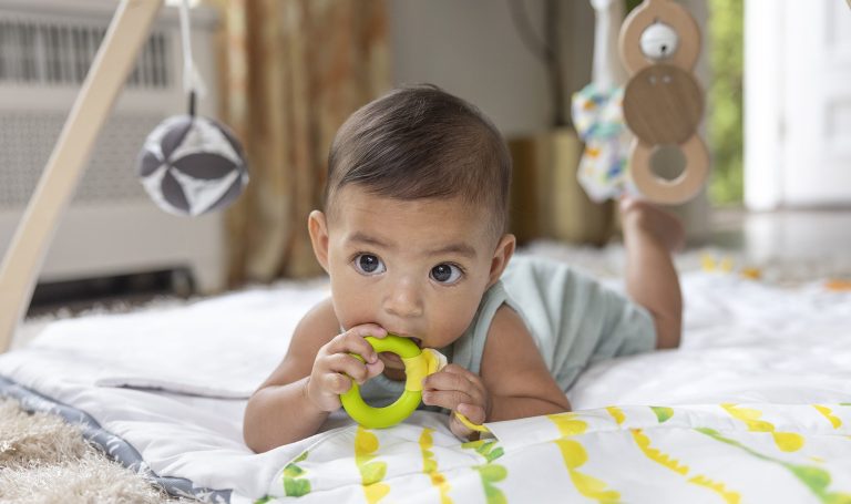 Baby chewing on a teething ring