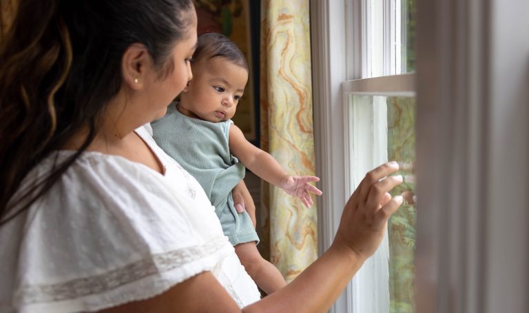 Baby and mother looking out the window