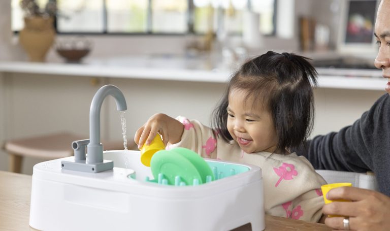 Toddler playing in the Lovevery sink