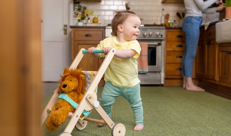 Toddler pushing a stroller