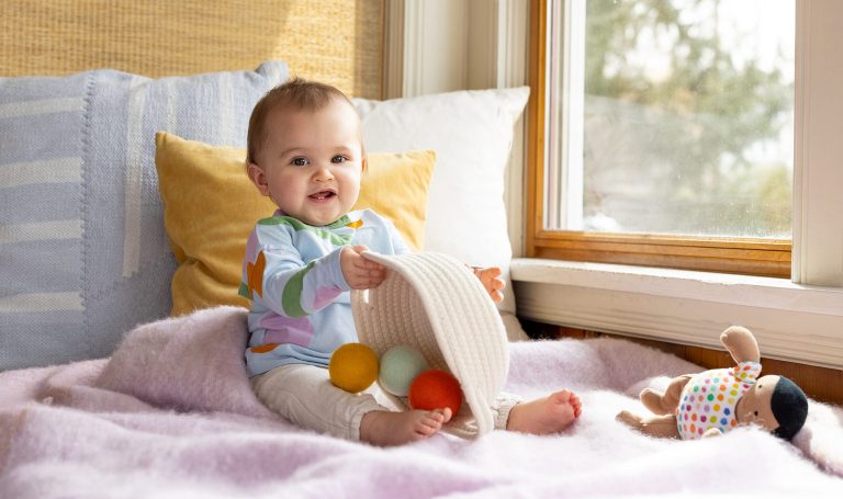 Baby playing with the Lovevery basket