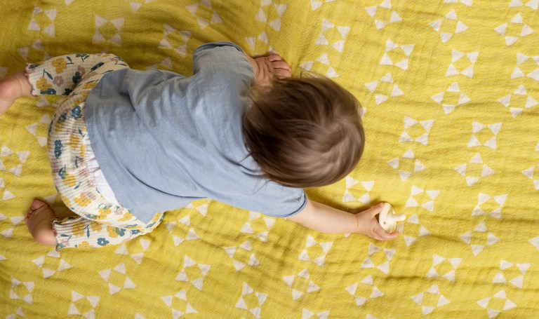Baby crawling on a blanket
