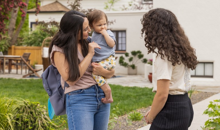 Baby looking at two women