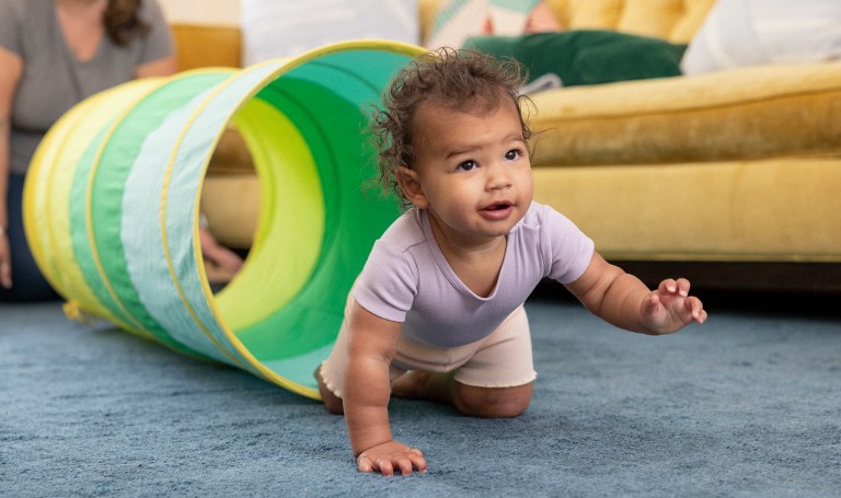 Toddler crawling through the Play Tunnel by Lovevery