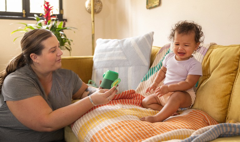 Toddler upset while their mom tries to play