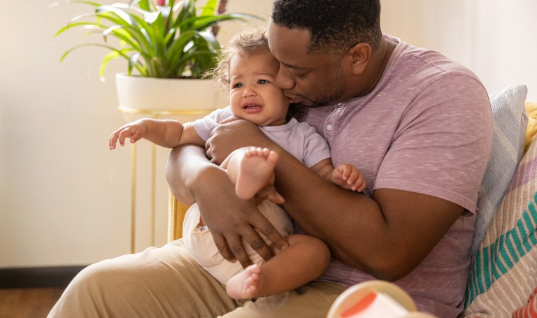 Father holding an upset baby