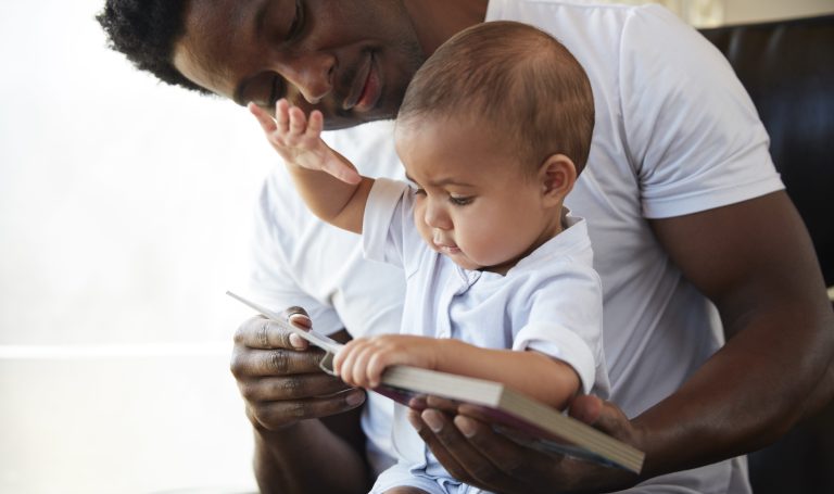 Father and baby looking at a book