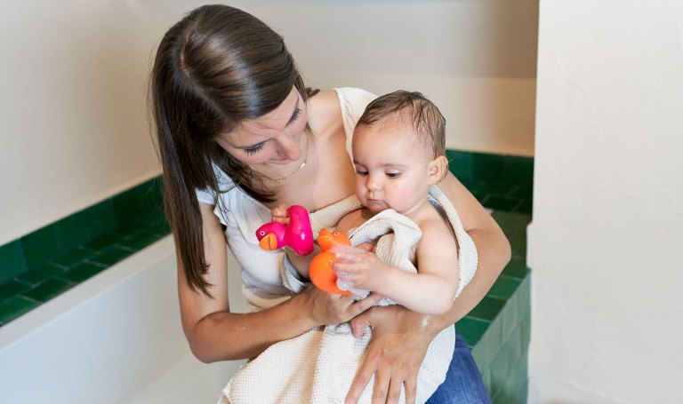 Mother holding a baby that just got out of the bath
