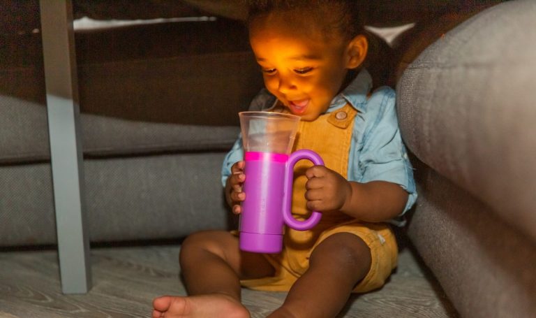 Toddler looking at the Lovevery Flashlight