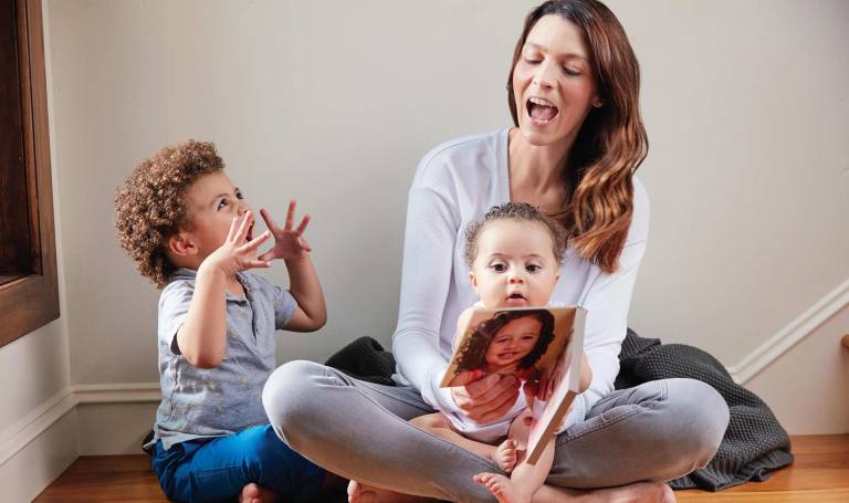 Mother reads to her children.