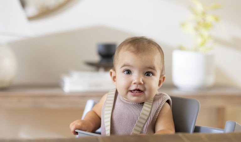 Baby sitting in a high chair