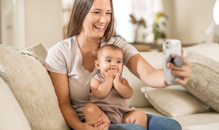 Mother taking a selfie with their baby