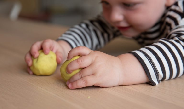 Toddler playing with dough