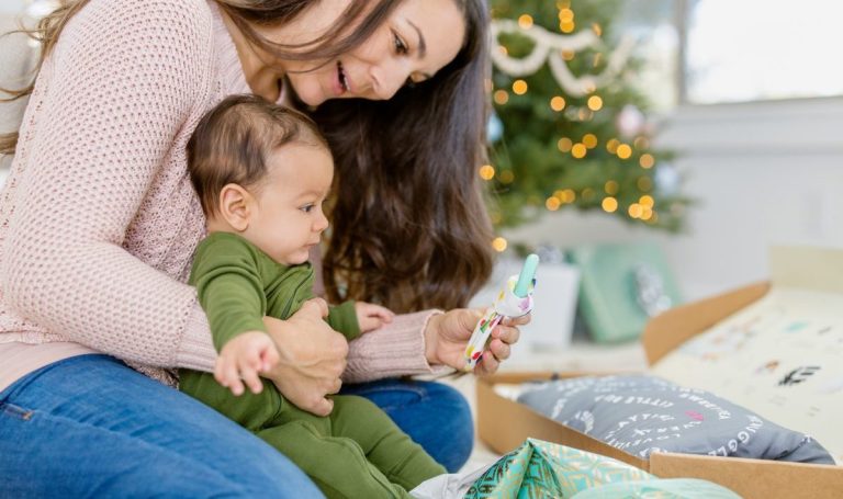 Mother and baby looking at a Lovevery toy