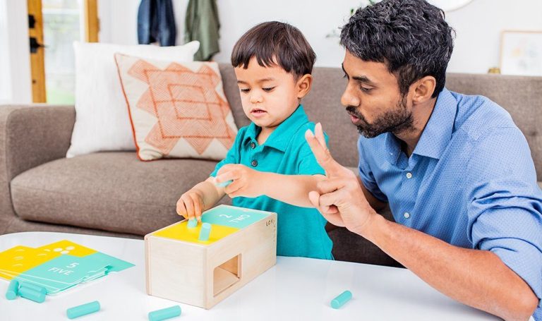 Toddler playing with the Wooden Counting Box by Lovevery